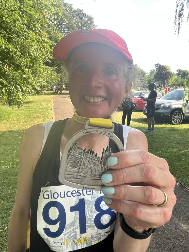 Gloucester 10k medal, Medal, Running, Runner, Gloucester 10k, Female runner in pink hat with medal