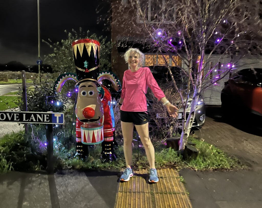 Gromit, Gromit Unleashed, Running, Runner, It is dark and a woman in shorts and a bright pink top stands next to a large sculpture of a cartoon dog dressed as The Nutcracker, Silent Sunday, My Sunday Photo