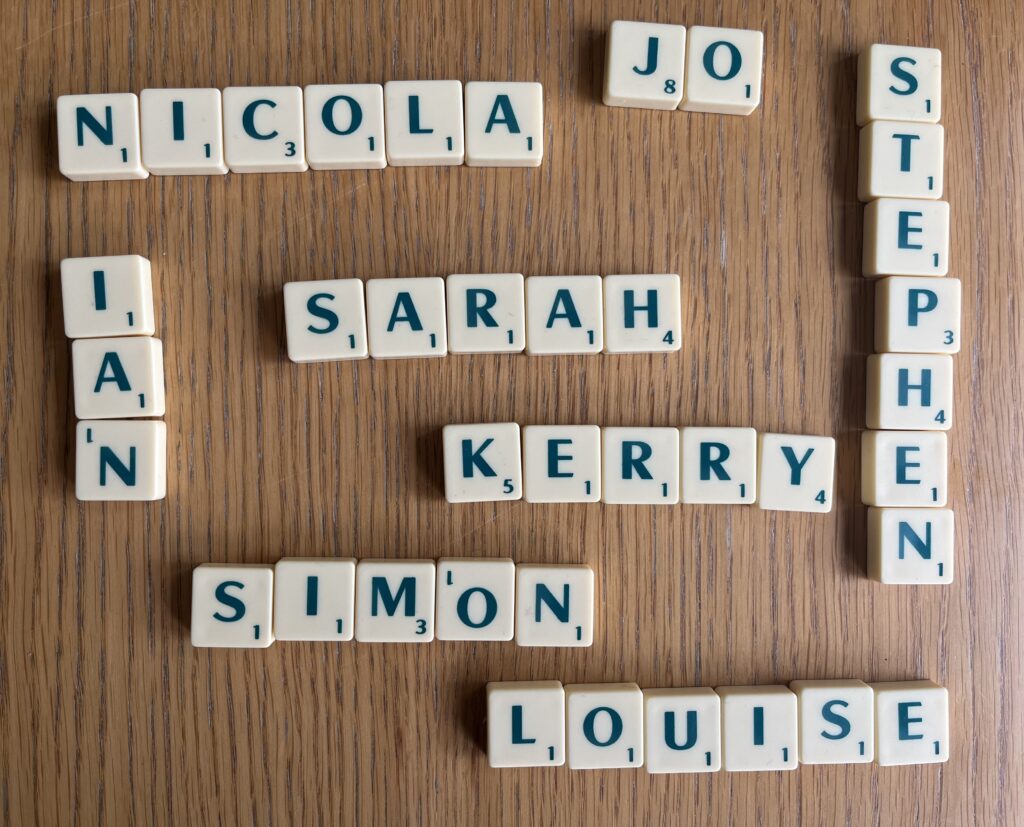 Sarah, Name, Scrabble tiles, Scrabble tiles sit on a wooden table spelling out names including Sarah Simon and Louise