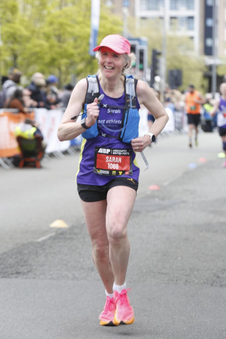 Newport marathon, Running, Runner, Running with a hydration vest, A female runner in a purple vest with a hydration back runs for the finish line