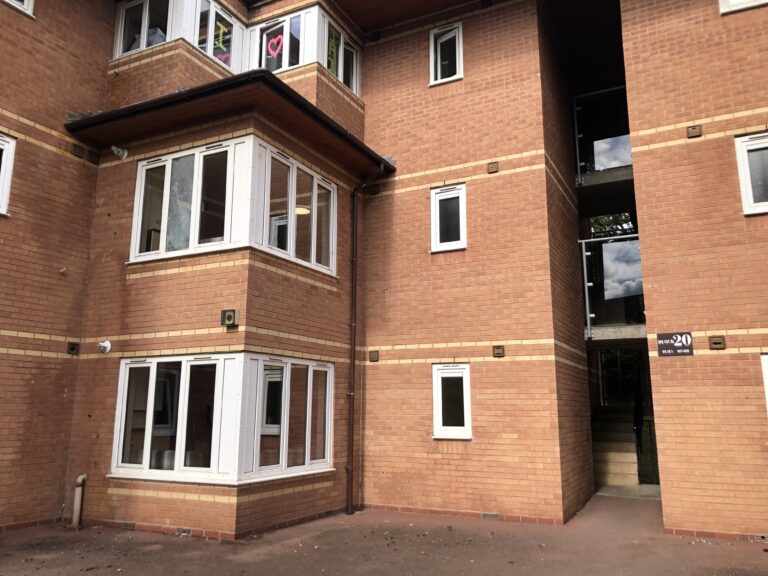 University, University halls, A red brick building with three floors and windows of various sizes with white frames
