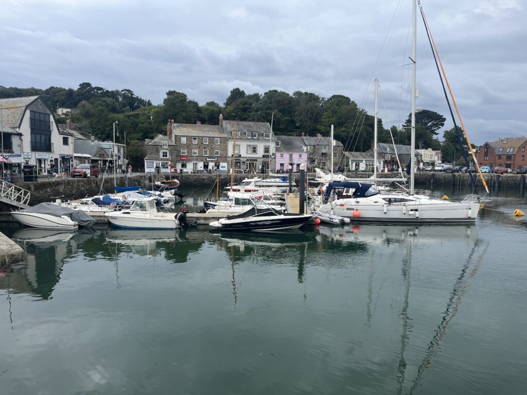 Padstow, Padstow harbour, Cornwall, Holiday, Silent Sunday, My Sunday Photo, Small boats on a harbour with a variety of old buildings in the background and trees behind them against a grey and cloudy sky
