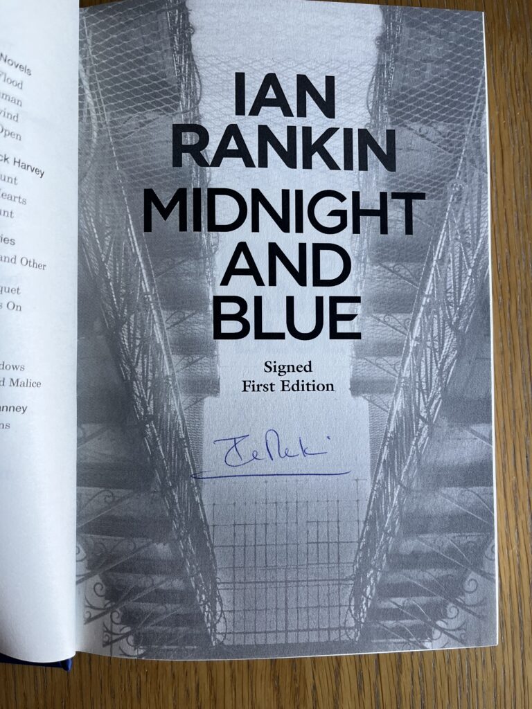 Midnight and Blue by Ian Rankin, Midnight and Blue, Ian Rankin, The grey and white title page of a book called Midnight and Blue by Ian Rankin has been signed in blue biro