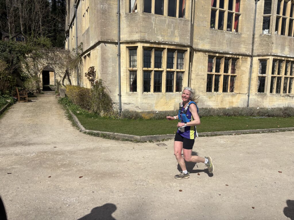 Cleevewold, Running, Runner, A smiling female runner runs in front of a light coloured building