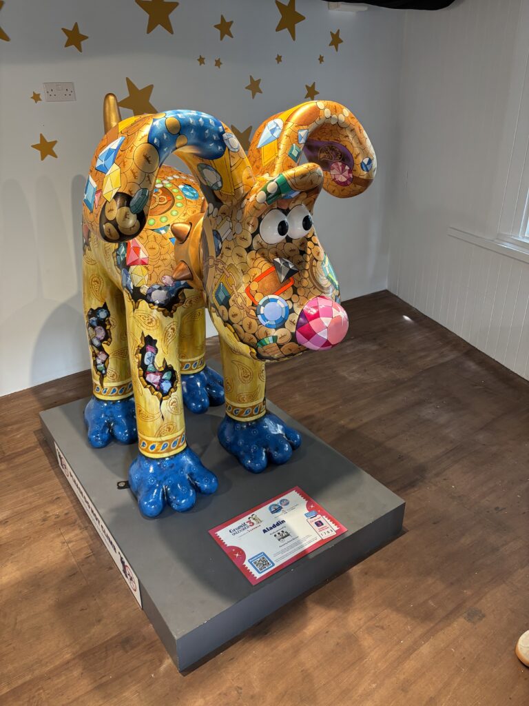 Gromit Unleashed 3, Gromit Unleashed, Wallace and Gromit, Bristol, Sculpture Trail, Silent Sunday, My Sunday Photo, A large mainly yellow Gromit dog sculpture decorated with painted jewels including a pink nose and blue feet