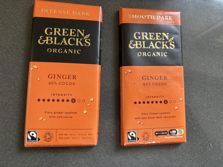 Green & Blacks, Chocolate, Ginger chocolate, Two chocolate bars wrapped in orange paper site next to each other and they both say Green & Blacks Organic Ginger but one says 50% and the other says 60%