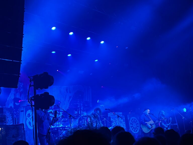 Levellers, Zeitgeist, Wolverhampton, KKs Steel Mill, Silent Sunday, My Sunday Photo, A band on stage bathed in blue lights with a crowd in front of them with three male guitarists and one violinist whose head is obscured by lights