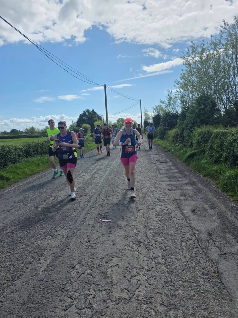 Newport marathon, Running, Runner, Marathon playlist, A country lane and blue sky with runners in the foreground and distance