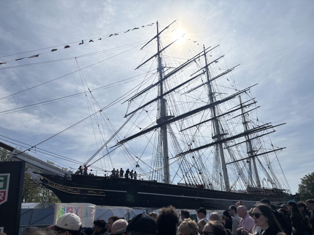 Cutty Sark, London, London marathon, An old fashioned ship silhouetted against a blue sky in front of a crowd of people