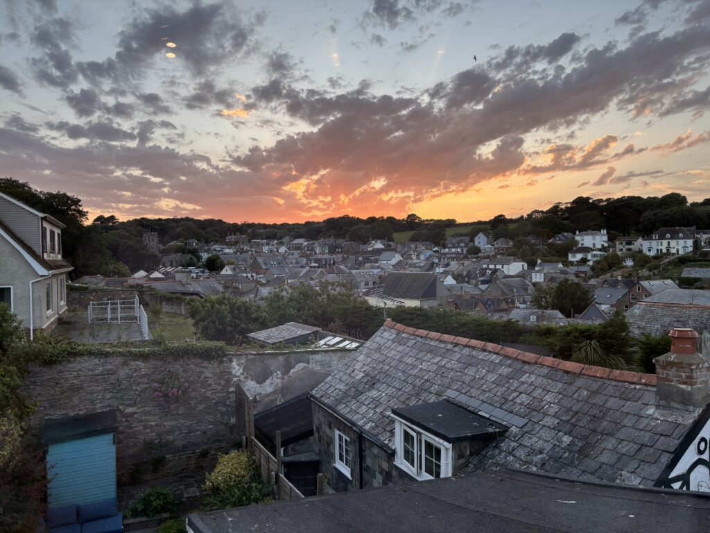 Padstow, Cornwall, Holiday, Sunset, View across the roofs of lots of old houses against a dramatic sky at sunset