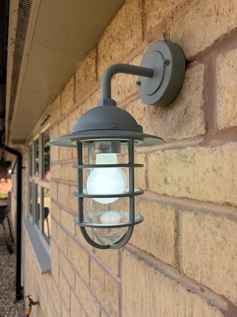 Lighting, Lights, Outdoor lighting, Home, Silent Sunday, My Sunday Photo, Light coloured bricks with a window visible in the background and a greenish grey light hanging from the wall