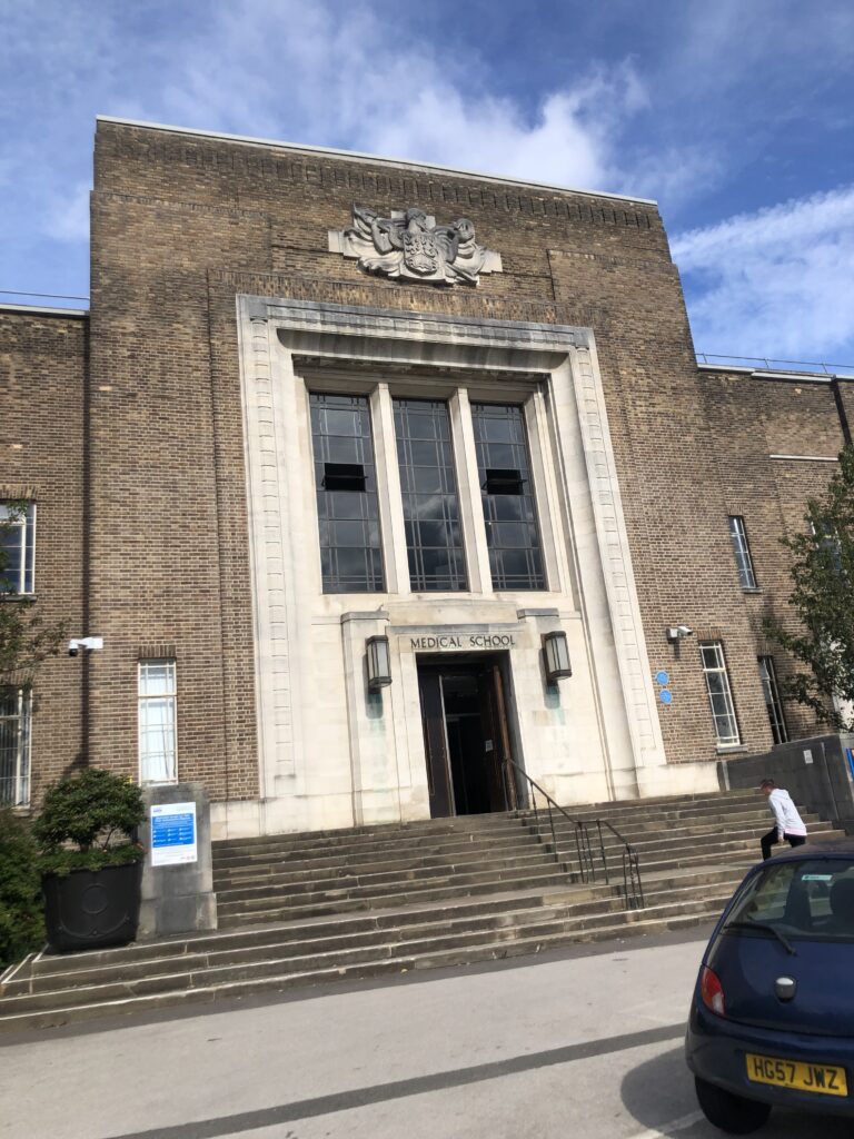 Medical School, University of Birmingham Medical School, Studying medicine, A tall brown brick building with stone steps leading up the entrance and the words Medical School above the front door